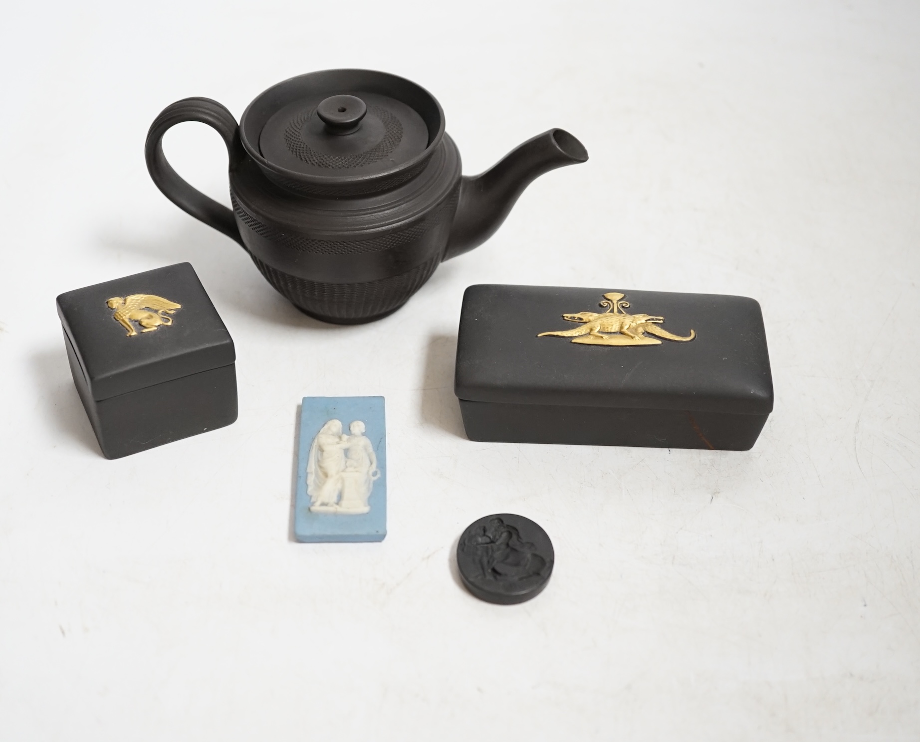 Wedgwood pieces comprising two plaques including a jasperware example and two small boxes, together with a black basalt teapot, largest 14cm wide. Condition - poor to fair